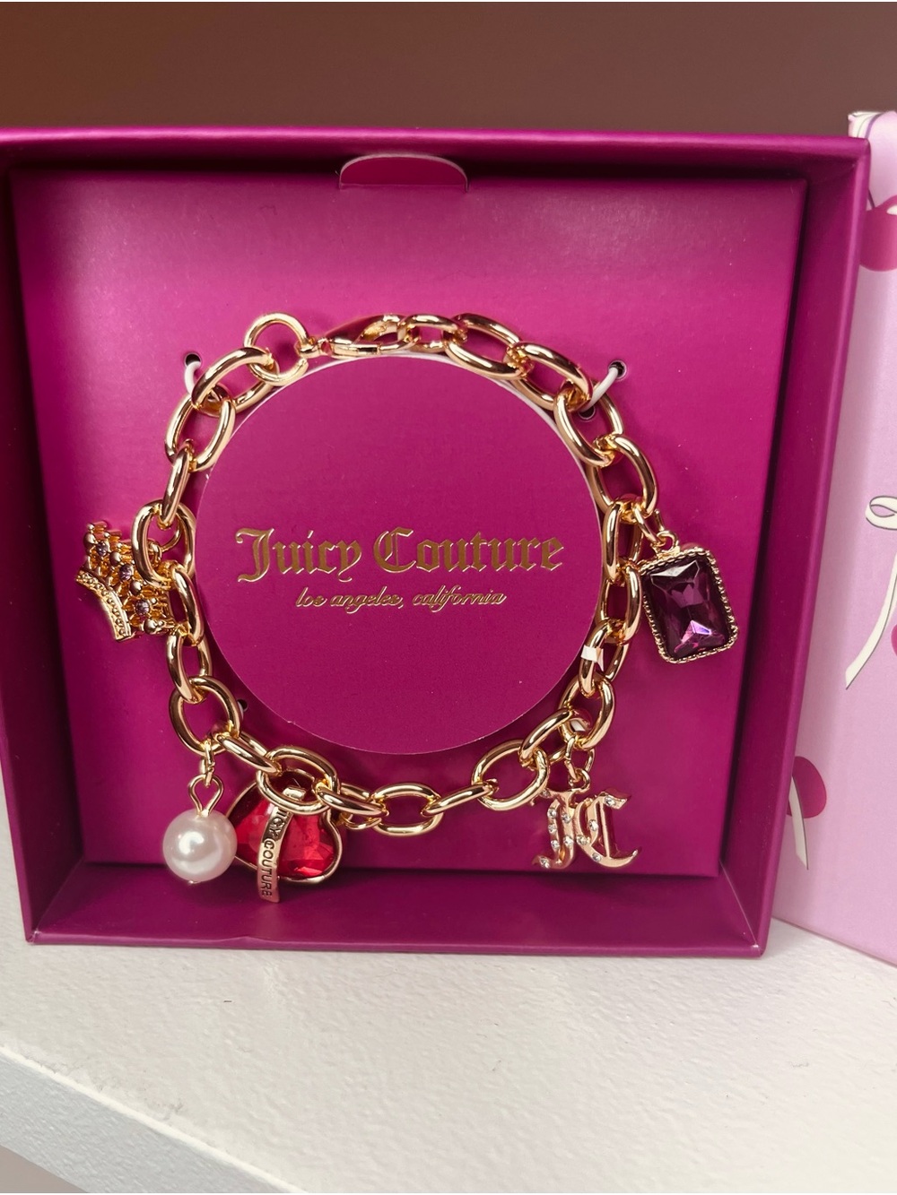 Juicy Couture Gold-Tone Charm Bracelet with Pink and Purple Gems